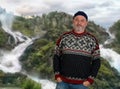 An elderly Norwegian with a sweater stands in front of the Latefossen double waterfall.