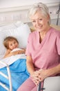 Elderly Nurse In USA Pediatrics With Child Patient