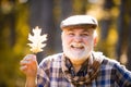 Elderly old man on autumn background - face portrait close up. Senior man hiking in autumn park. Golden age grandfather Royalty Free Stock Photo