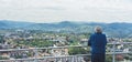 Elderly old man looking on observation deck in trip holiday in Bilbao, pensioner enjoying view on seascape on mountain and ocean