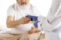 Elderly old man recovering in a hospital bed isolated on white Royalty Free Stock Photo