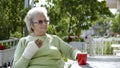 Elderly old woman with injured hand drinking coffee Royalty Free Stock Photo