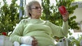 old woman with injured hand drinking coffee outdoor Royalty Free Stock Photo