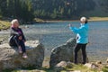 An elderly pair of women captures a timeless moment on their smartphones, blending technology with the serene beauty Royalty Free Stock Photo