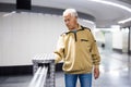 Elderly passenger pays for a metro ride using mobile phone