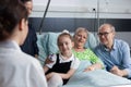 Surgeon visiting grandmother bedridden in sanatorium room