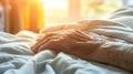 Elderly Patient s Hand Resting on Hospital Bed Amidst Warm Morning Light and Tranquil Ambiance