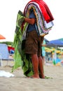 elderly peddler with towel and clothes Royalty Free Stock Photo