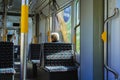 An elderly pensioner rides in an empty tram