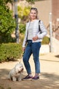 Elderly pensioner woman walk park white small dog