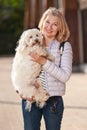 Elderly pensioner woman walk park white small dog