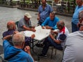 ACITREZZA, ITALY, CIRCA AUGUST 2021 elderly pensioners play cards on the street after lockdown due to covid-19 Royalty Free Stock Photo