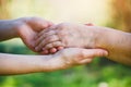 elderly people care concept, young female hands holding wrinkled hand of senior woman Royalty Free Stock Photo