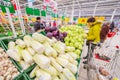 Elderly people choose vegetables in a large shopping center.