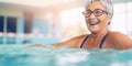 Elderly people doing exercise in swimming pool. Cheerful active senior woman practicing water aqua aerobics in gym