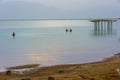 People enjoying the Dead Sea at golden hour Royalty Free Stock Photo