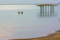 People enjoying the Dead Sea at golden hour Royalty Free Stock Photo