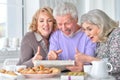 Elderly people having breakfast and reading a newspaper Royalty Free Stock Photo