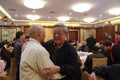 Elderly people hugging at the banquet in a restaurant Royalty Free Stock Photo