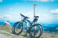 Elderly people, man and woman, enjoy the view of the mountains, relax in the mountains after a bike ride.