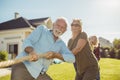 Elderly people participating in rope pulling competition at retirement home Royalty Free Stock Photo