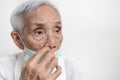 Elderly people is picking nose with finger inside,Do not touch nose with dirty hand,avoid touching,prevention form COVID-19,risk Royalty Free Stock Photo