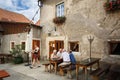 Elderly people sitting at a table in a street restaurant. Weissenkirchen in der Wachau, Austria.