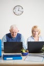 Elderly people working on laptops Royalty Free Stock Photo