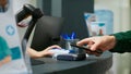 Elderly person paying medicaments and drugs with telephone and nfc