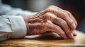An elderly person& x27;s hands resting on a wooden table, AI Royalty Free Stock Photo