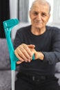 Elderly person standing with hands resting on medical walking stick. Concept of person with immobility, joints, rheumatism problem Royalty Free Stock Photo