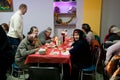 Elderly poor women have a food at the Christmas charity dinner for the homeless