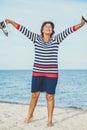 Elderly pretty woman enjoys relaxing by the sea