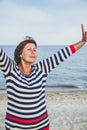 Elderly pretty woman enjoys relaxing by the sea