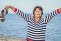 Elderly pretty woman enjoys relaxing by the sea