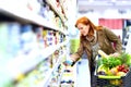 elderly pretty woman shopping for fresh healthy food in the supermarket Royalty Free Stock Photo