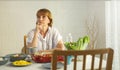 Elderly retired grandmother stay at home with unhappy face sitting alone on eating table in house. Depressed mature Senior old Royalty Free Stock Photo