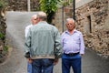 Elderly and retired people chatting on a street in a town