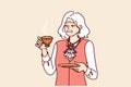 Elderly aristocrat woman drinks tea from golden mug and is dressed in exquisite expensive clothes