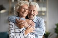 Elderly 65s couple in love embracing smile look at camera Royalty Free Stock Photo