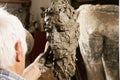 Elderly sculptor modelling sculpture