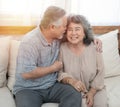 Elderly senior asian couple happy together at home.Grandfather and grandmother sit on coach in living room at home have leisure Royalty Free Stock Photo