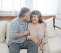 Elderly senior asian couple happy together at home.Grandfather and grandmother sit on coach in living room at home have leisure Royalty Free Stock Photo