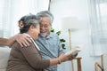 Elderly senior asian couple sitting on sofa reading book together at home.Retirement grandmother and grandfather spend time Royalty Free Stock Photo