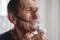 Elderly senior with an oxygen mask in quarantine