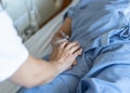 Elderly Senior Patient Ageing Old Adult Person Lying In Hospital Bed With Family Caregiver Or Caretaker Nurse In Nursing