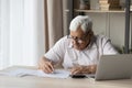 Elderly senior 80s man in glasses doing paperwork at home Royalty Free Stock Photo