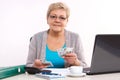 Elderly senior woman counting cash for utility bills at her home, financial security in old age Royalty Free Stock Photo