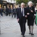 An elderly serious couple goes to the theater at Covent Garden