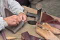 Elderly shoemaker makes artisan shoes